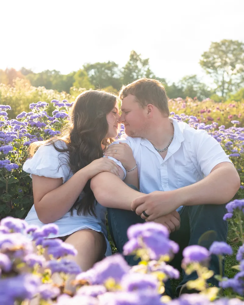 A couple laughing together during a relaxed outdoor photo session.